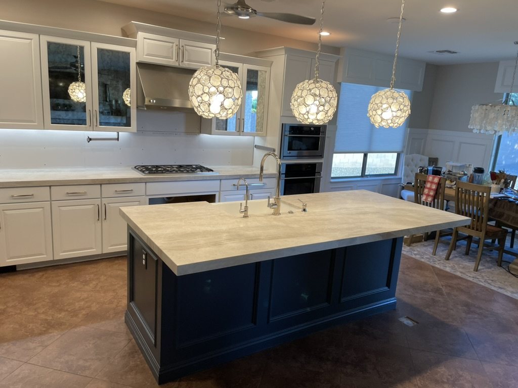 Navy blue kitchen island with Taj Mahal quartzite countertop and crystal pendant lights, Gilbert, AZ
