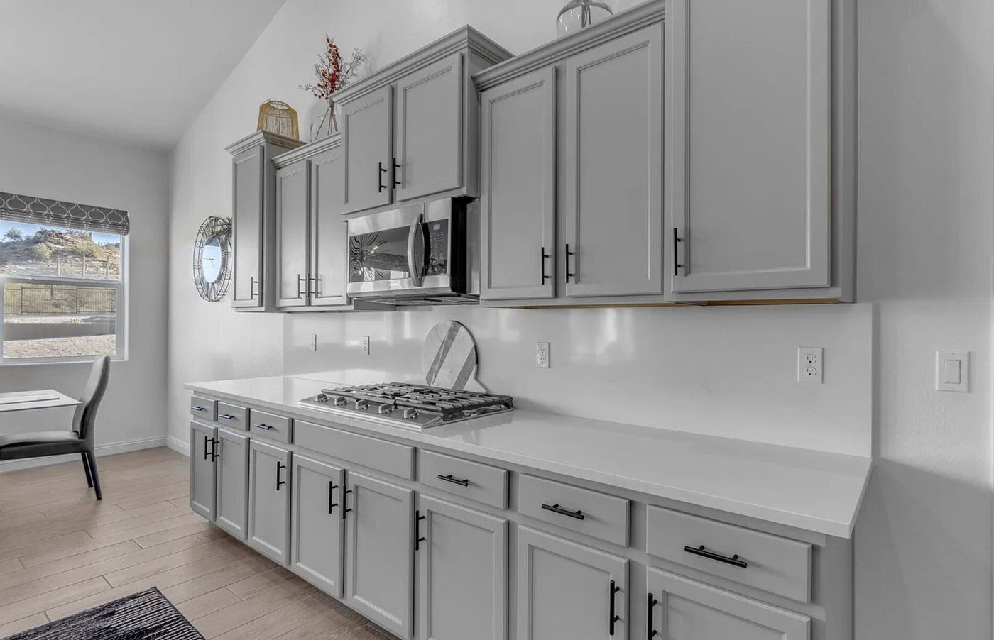 Quartz counter run with a gas cooktop and full-height backsplash, San Tan Valley, AZ kitchen