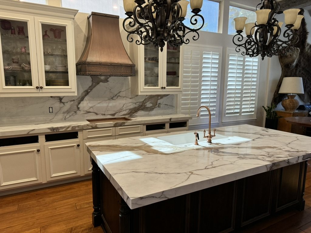Quartz island with a copper faucet under an iron chandelier, Ahwatukee, AZ kitchen