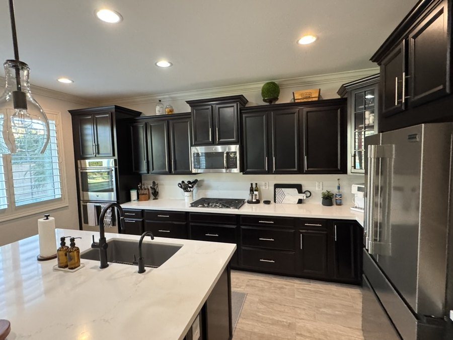 Quartz kitchen island and perimeter counters with dark cabinetry and double ovens, Chandler, AZ