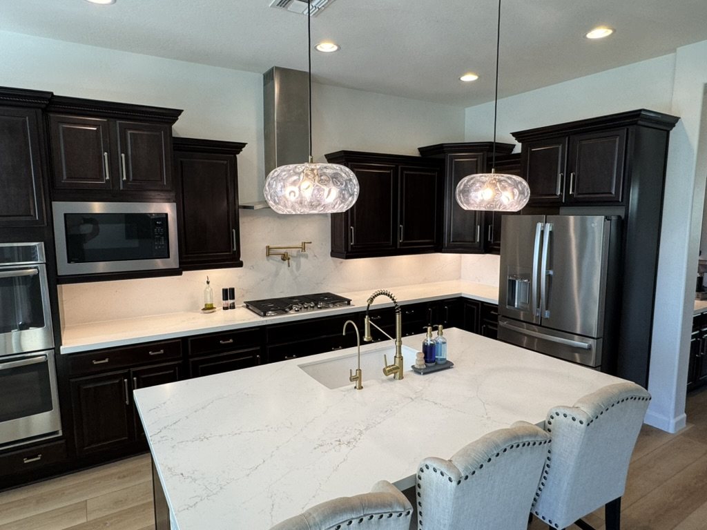 Quartz kitchen island with vein-matched backsplash and dark espresso cabinetry, Gilbert, AZ