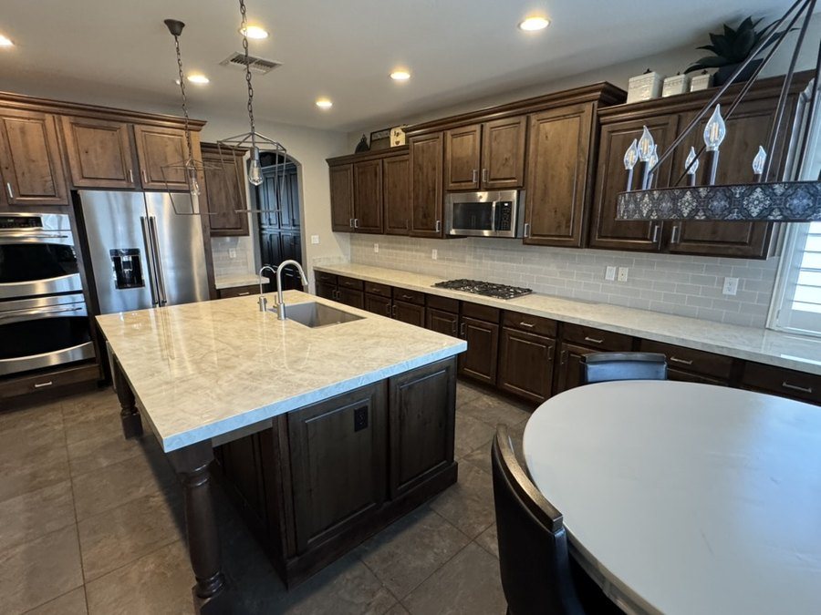Porcelain island top and perimeter counter run beside the cooktop, Chandler, AZ kitchen