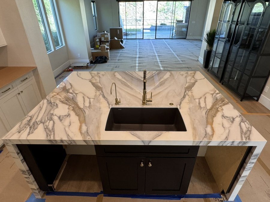 Bookmatched porcelain waterfall island with undermount sink and gold fixtures, Fountain Hills, AZ