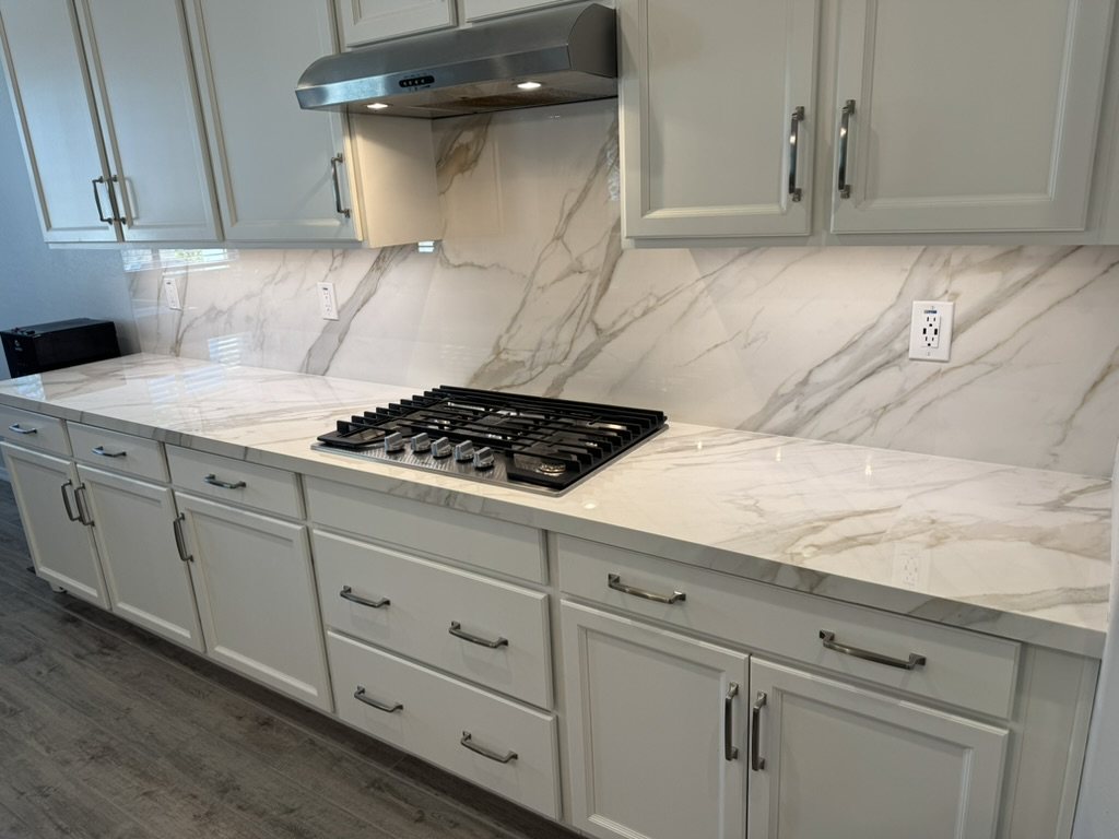 Quartz kitchen cabinet run with vein-matched full-height backsplash, Mesa, AZ