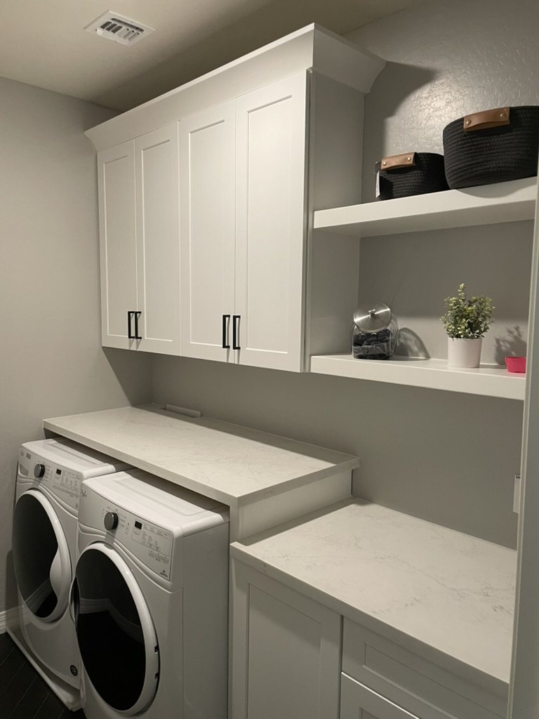 Laundry room with white shaker cabinetry, open shelving and a quartz counter over the washer and dryer, Mesa, AZ